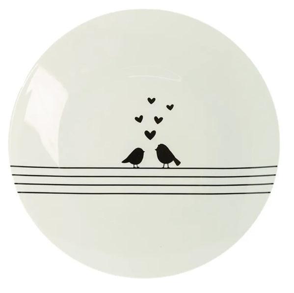 Piatto in ceramica Clayre & Eef con due uccellini stilizzati e cuori neri su fondo bianco.