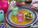 Vassoio Modern Vesta Ø38 cm in melamina con pattern geometrico, perfetto per aperitivi outdoor con bicchieri colorati e mise en place estiva