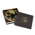 Piatti piano midnight Exotic Jungle di Simone Guidarelli con confezione regalo elegante nera e dettagli dorati.