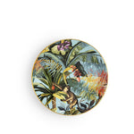 Piatto frutta Exotic Jungle Heavenly di Simone Guidarelli con motivi tropicali e scimmia su fondo azzurro chiaro.